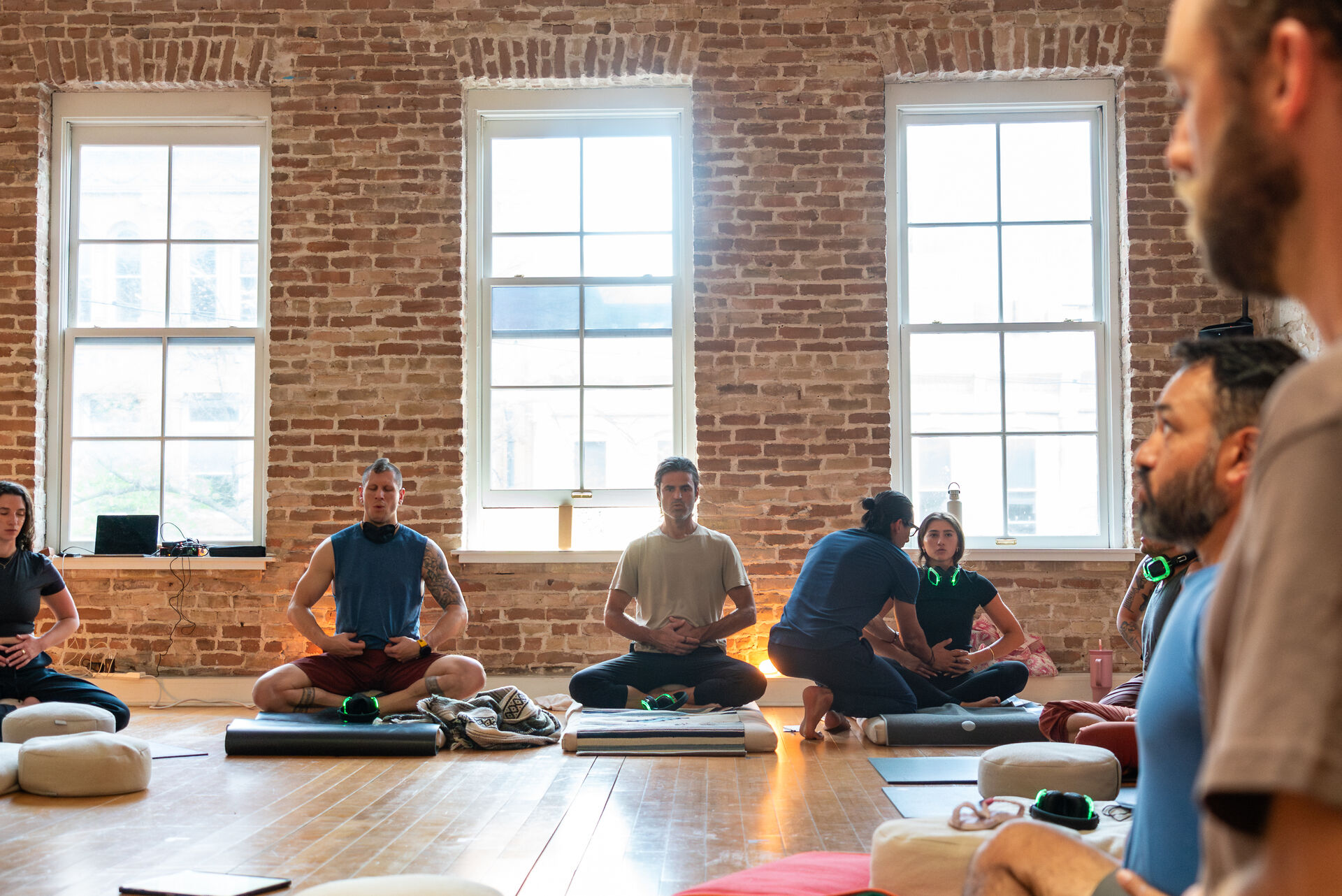 A group seated in a circle after a guided practice